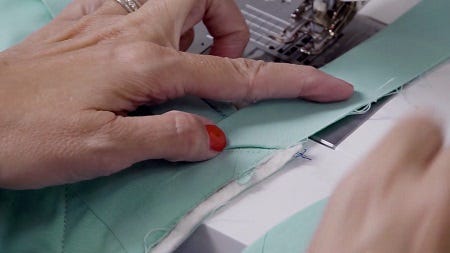 Fold the binding strip away at a 45-degree angle